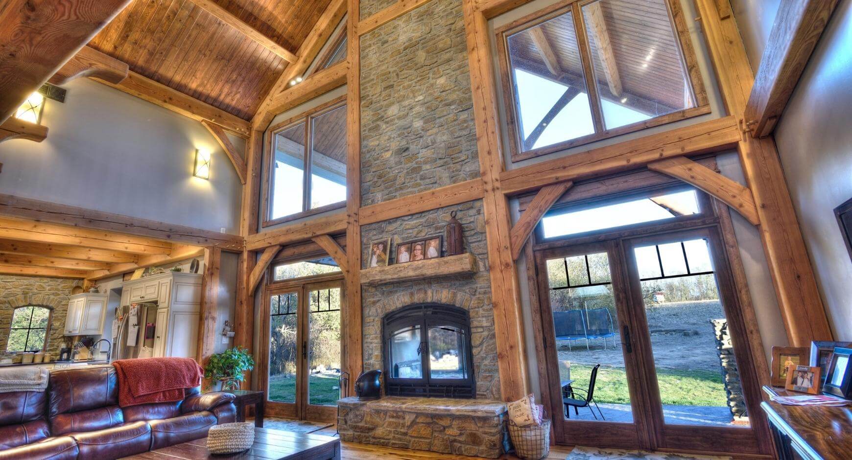Tall stone chimney fireplace in log cabin 