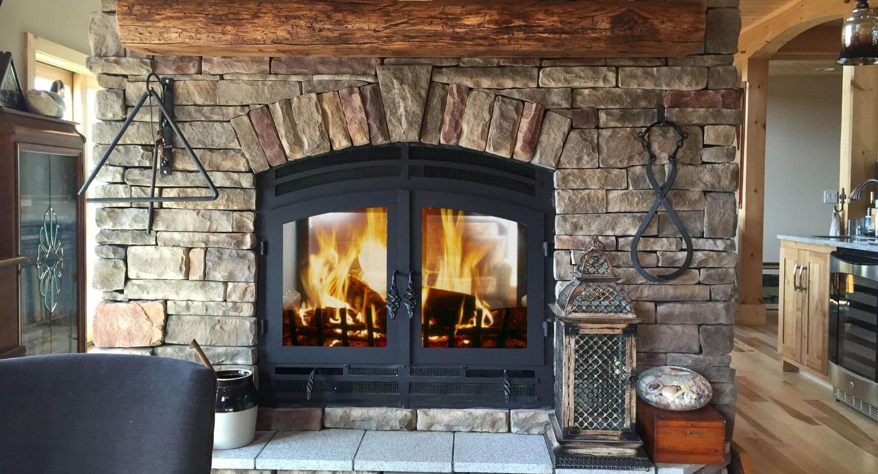 Wood fireplace burning behind glass doors