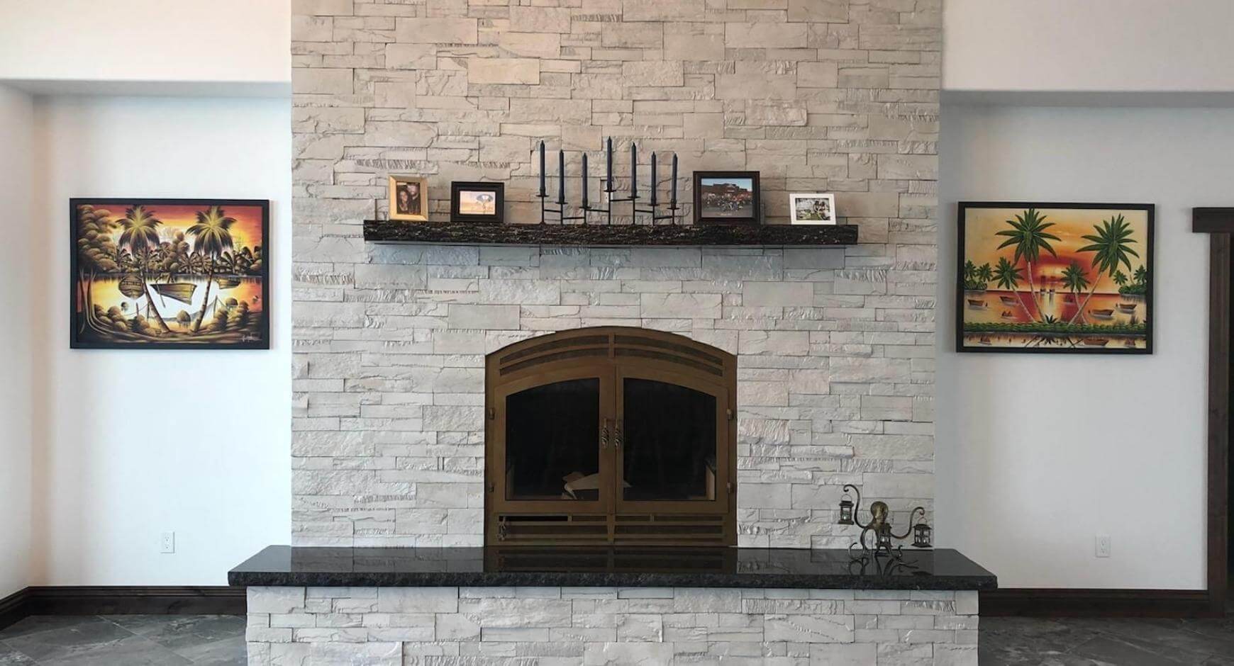Dark bronze fireplace with a white stone facade