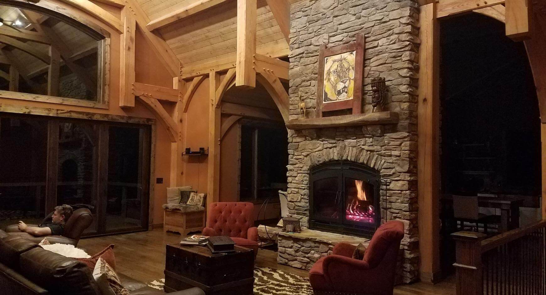 Stone wood fireplace in log cabin