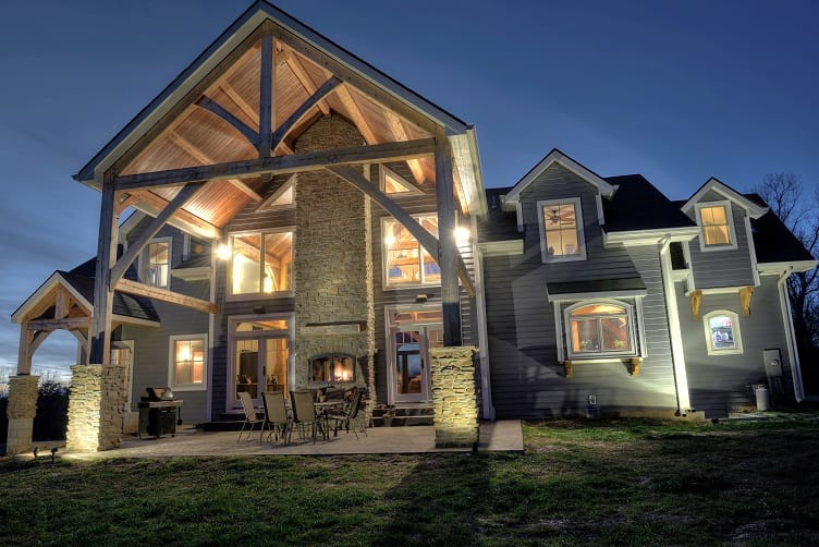 a home's patio with an indoor/outdoor fireplace