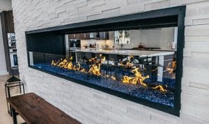 linear fireplace with glass barrier and blue crushed glass media