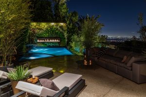 linear outdoor gas fireplace above pool in living wall overlooking downtown los angeles