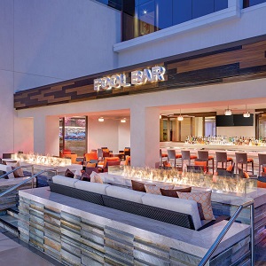 acucraft dual custom outdoor fire tables at pool bar in casino