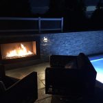 acucraft custom outdoor fireplace next to pool