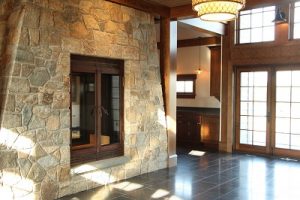 large custom wood burning fireplace in private residence entryway