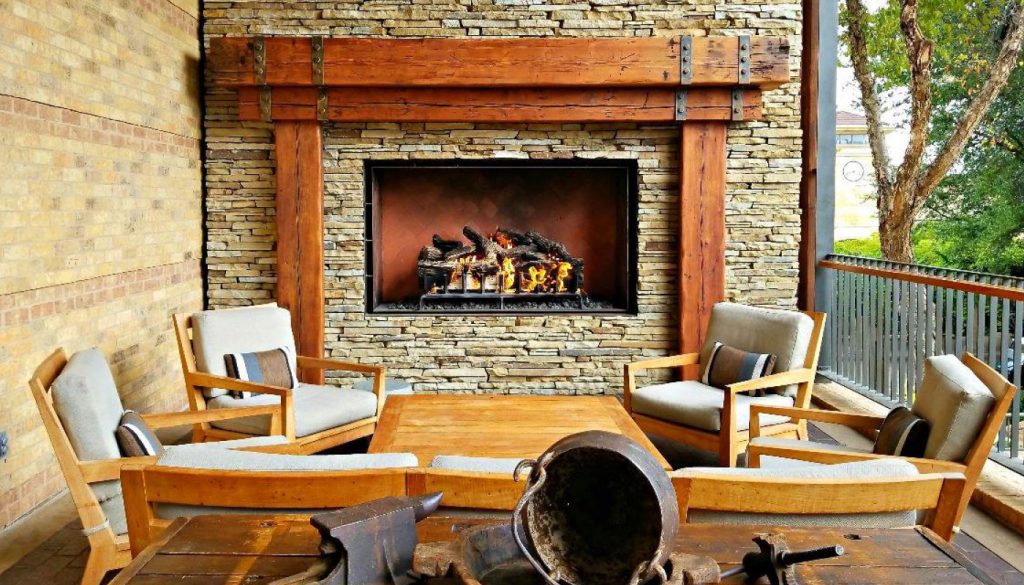 outdoor gas fireplace with logs on patio