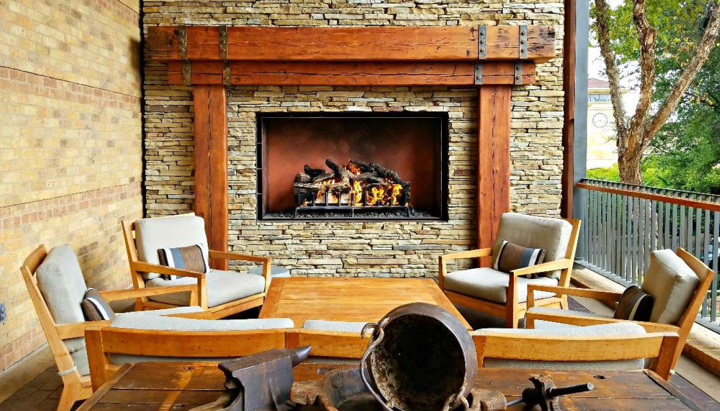 outdoor gas fireplace with logs on patio