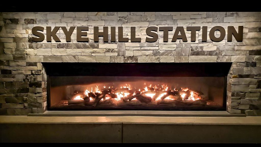 Acucraft custom outdoor see through gas fireplace at Skye Hill Station