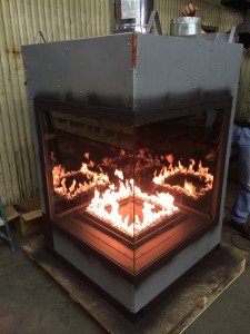 acucraft custom corner gas fireplace being tested with square burner