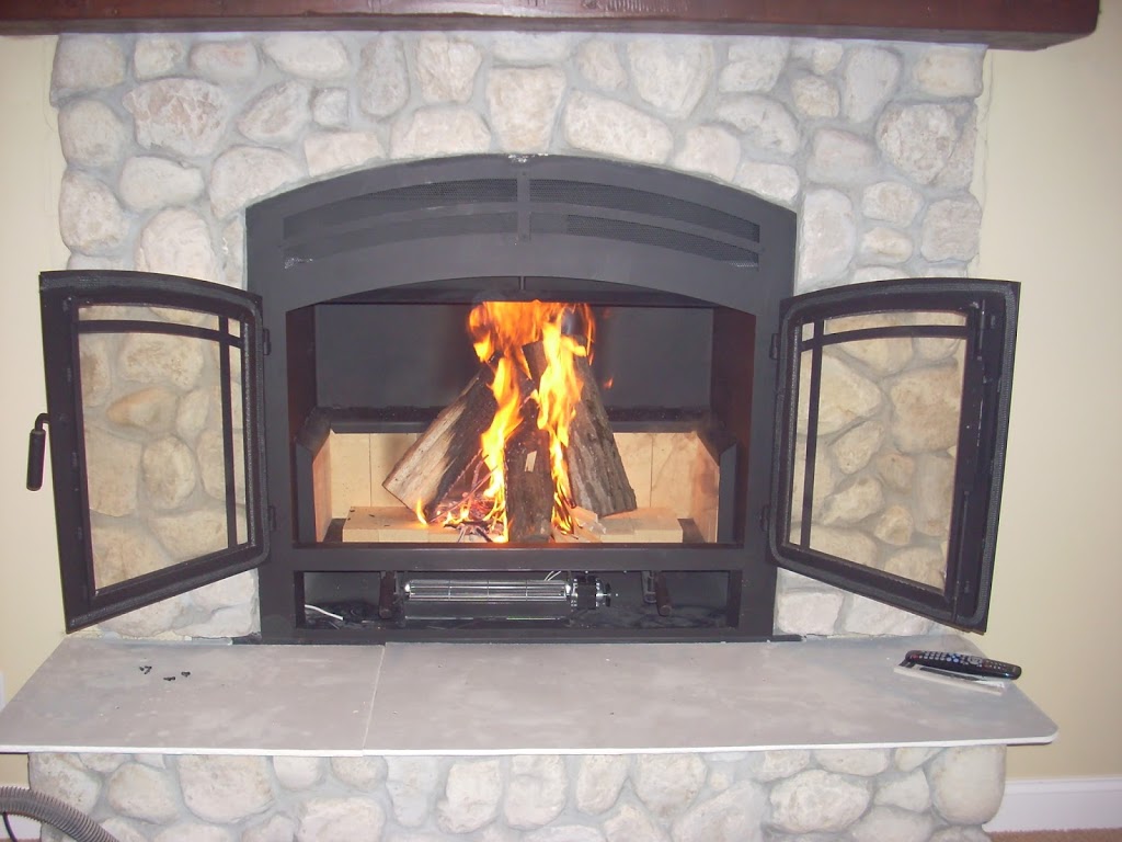 wood burning fireplace with open doors