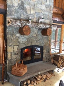 see through indoor outdoor wood fireplace exterior side