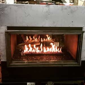 custom linear see through gas fireplace being tested and manufactured