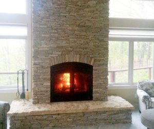 indoor outdoor wood fireplace in new construction home