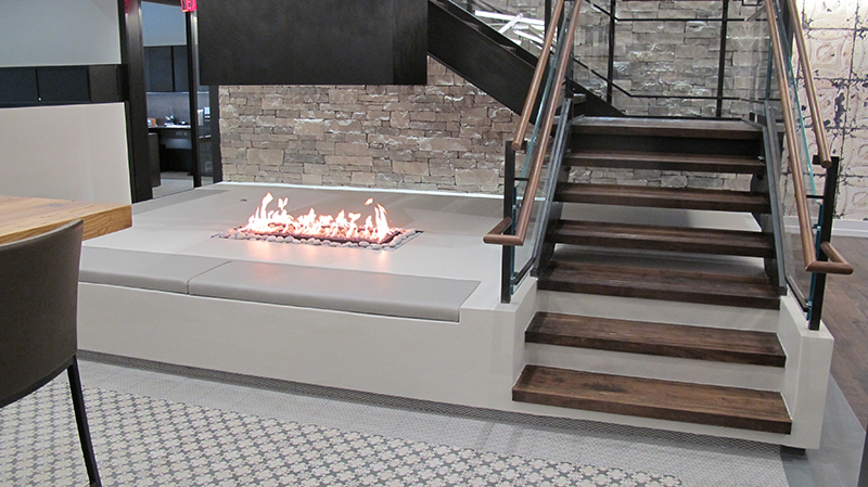 custom open gas fireplace with suspended hood in corporate office