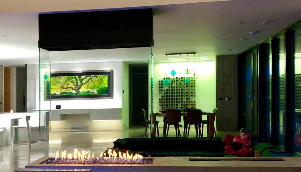 acucraft custom four sided indoor gas fire pit with open viewing area and suspended glass and hood in sunken living room