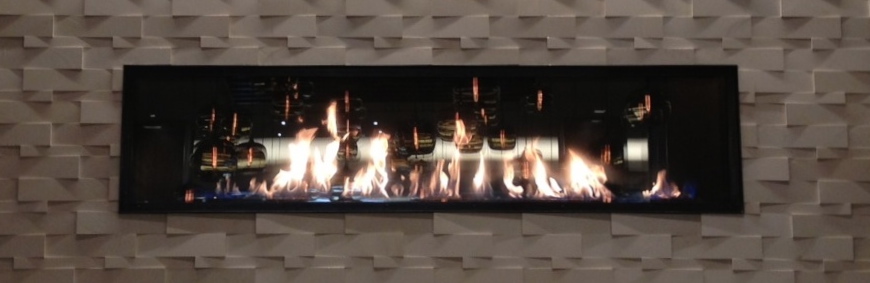 acucraft linear gas fireplace with reflective panels in hotel bar