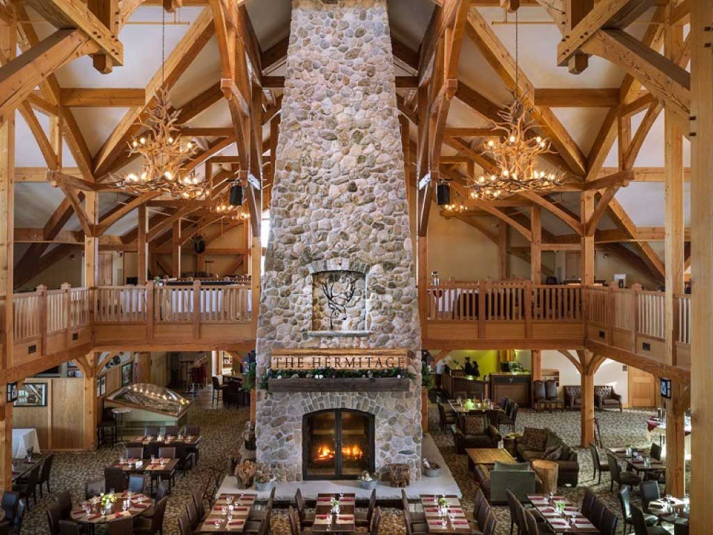 custom four sided wood fireplace at ski lodge