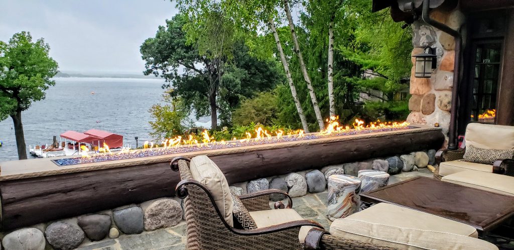 Acucraft custom gas outdoor burner with cobalt reflective glass media, adding a sleek and modern fire feature to enhance the patio experience.