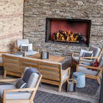outdoor open gas fireplace with logs at four seasons resort bar