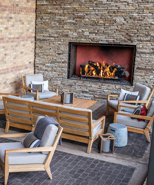 outdoor open gas fireplace with logs at four seasons resort bar