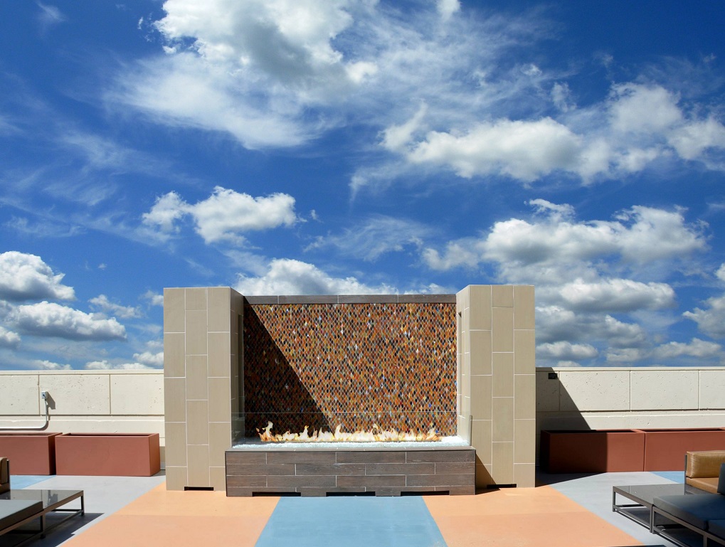 outdoor fire table with mosaic backdrop rooftop patio