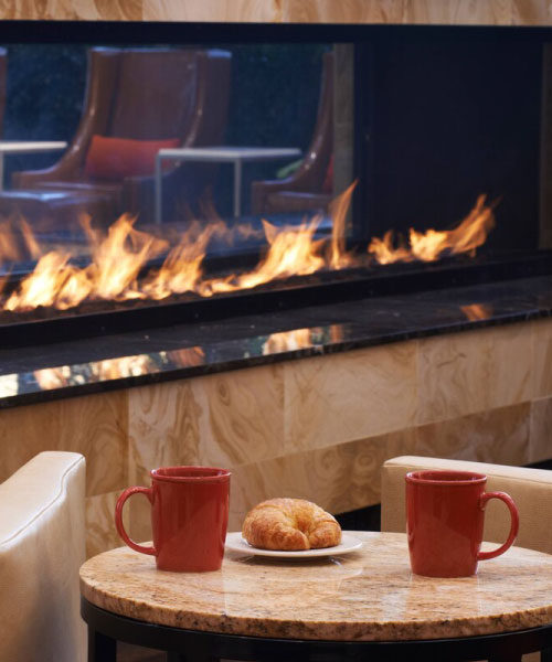 linear see through gas fireplace in hotel lobby