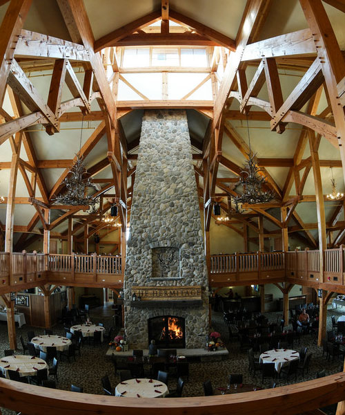 custom 4 sided wood fireplace in ski resort dining area