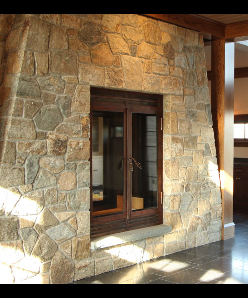 custom single sided wood fireplace with patina finish and stone surround