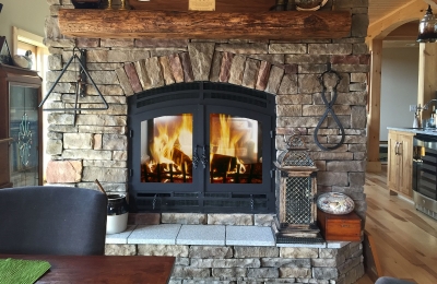 see through wood burning fireplace in rustic home