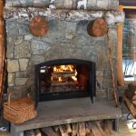 see through indoor outdoor wood burning fireplace with open doors