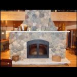 single sided wood burning fireplace with stone surround