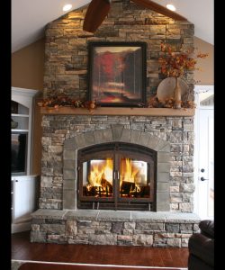 see through wood burning fireplace with stone finish
