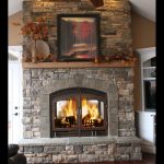 see through wood burning fireplace with stone finish