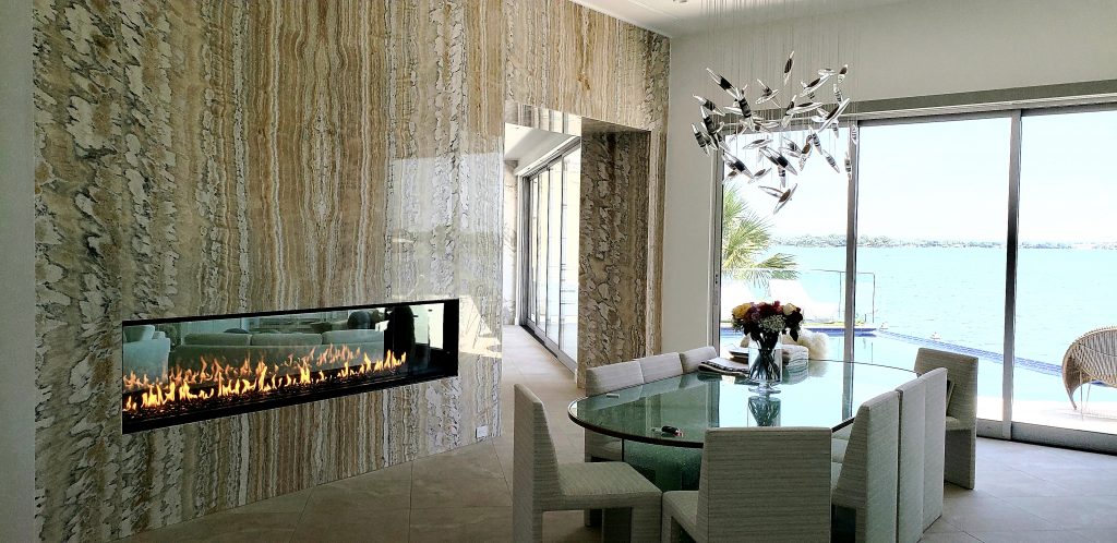 modern coastal home with linear double sided gas fireplace