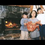 cooking in wood burning fireplace with family