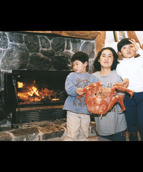 cooking in wood burning fireplace with family