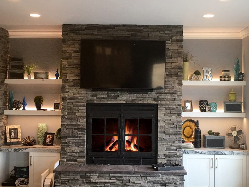 contemporary wood-burning fireplace with a TV mounted above