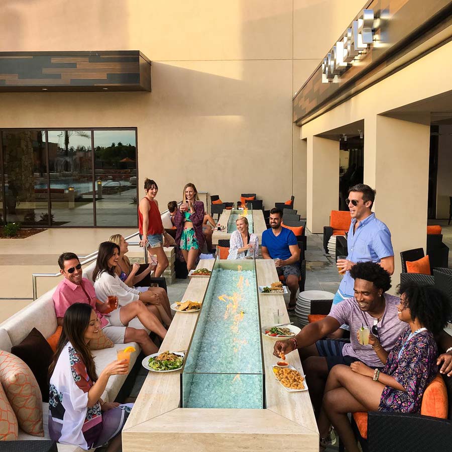 people enjoying food on a fire table