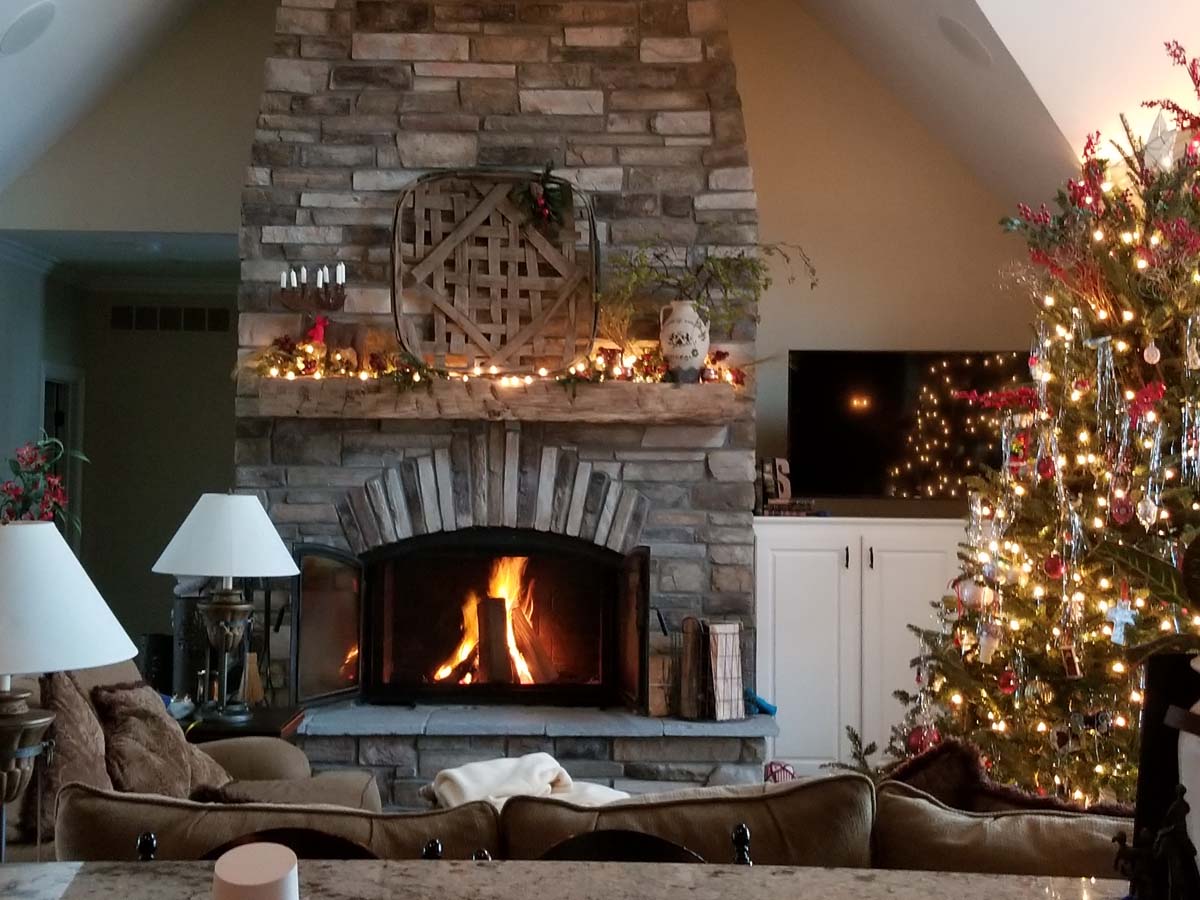 winter wood burning fireplace with christmas tree 