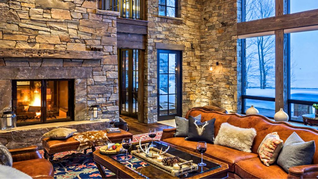 double sided wood burning fireplace in a living room in a cabin