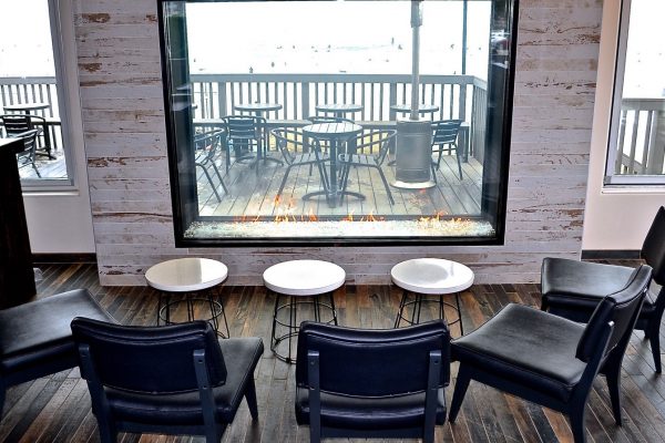 indoor outdoor see through gas fireplace overlooking the beach