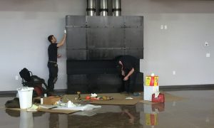 Fireplace technicians servicing a fireplace