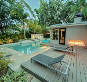 florida beach home with poolside patio and linear double sided gas fireplace