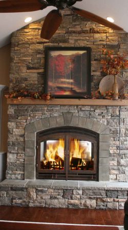 rustic-family-room-acucraft-wood-fireplace-indoor-outdoor