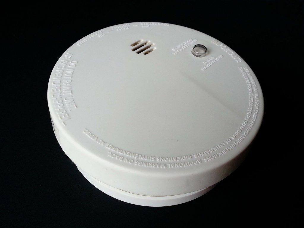 a circular white smoke detector 