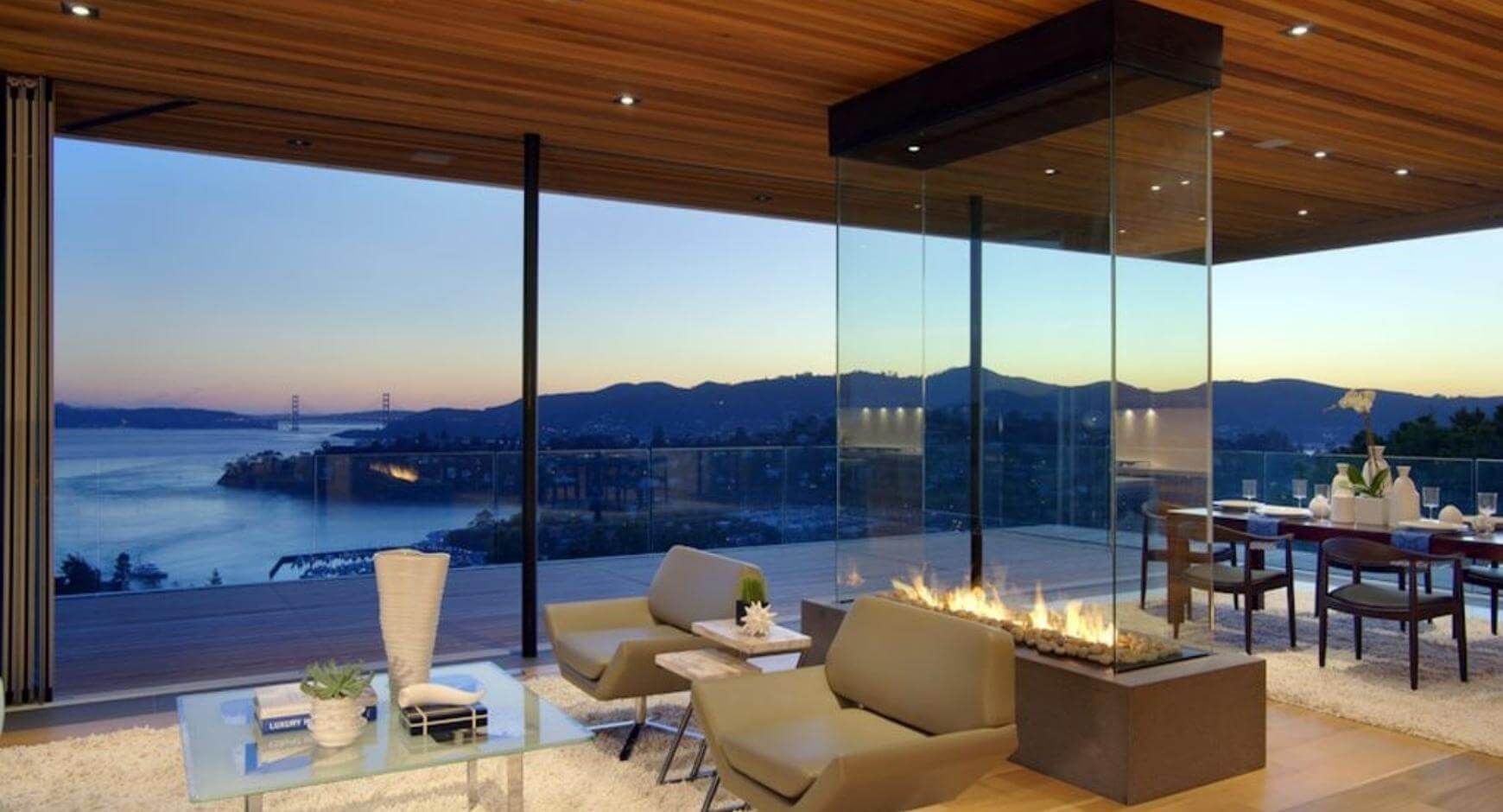 four sided glass fireplace with a mountain view