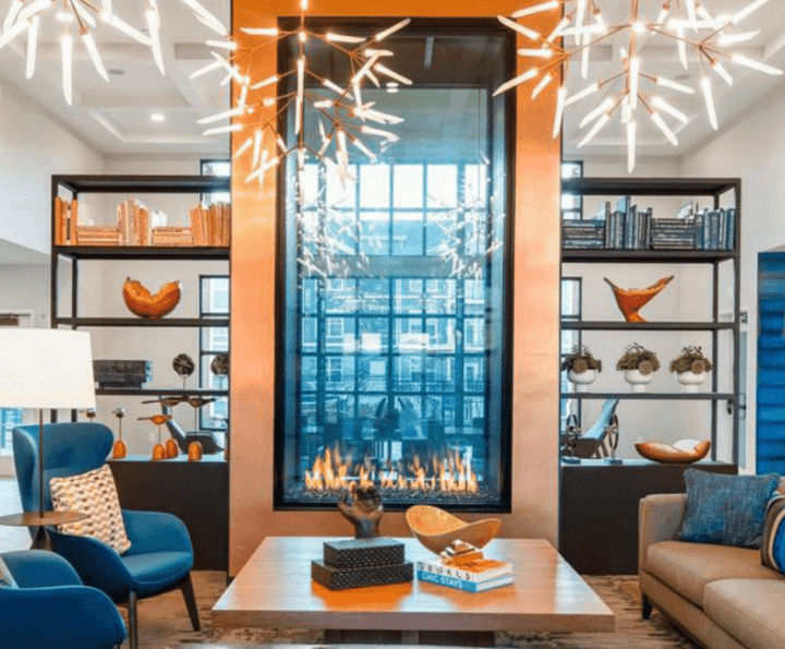 Personalized home interior centered around a large, see-through, copper-framed fireplace