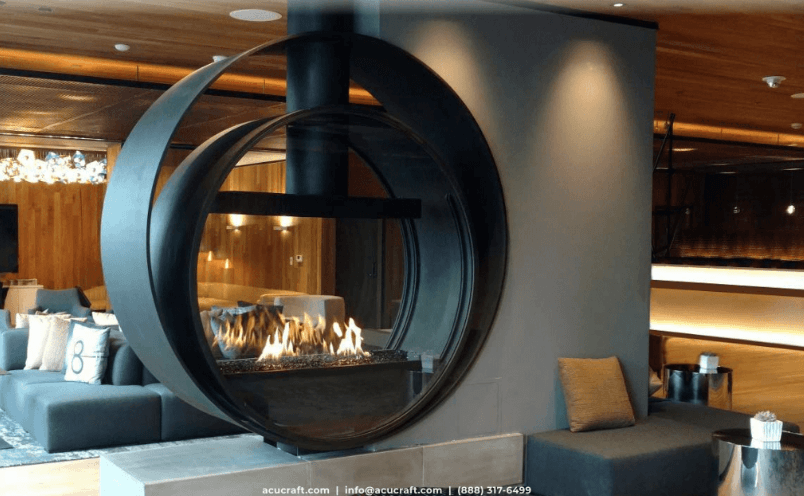 Modern home interior focused on a large, circular, see-through fireplace