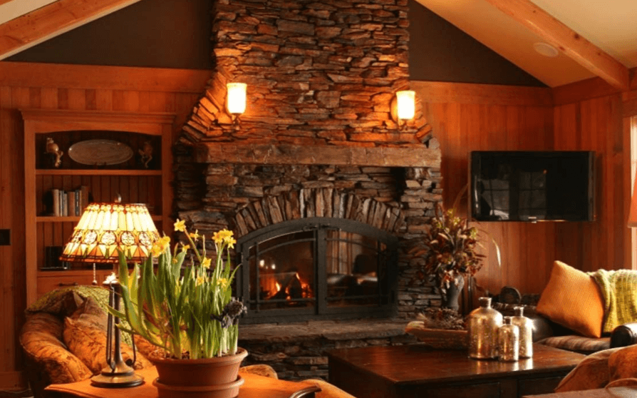 Cottage-style home with a stonework fireplace